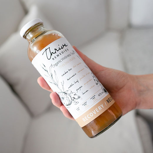 recovery-turmeric-tea-square bottle of recovery in a woman's hand