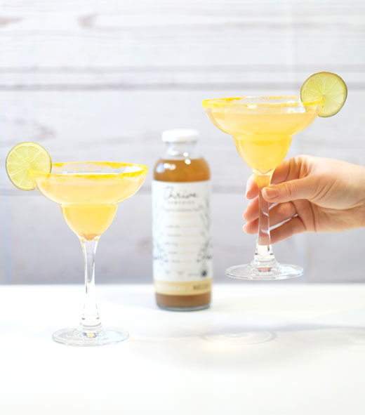ginger-margarita-recipe two ginger margaritas with a bottle of recovery in the background