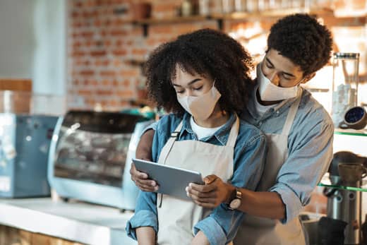 beverage-industry cafe workers looking at an Ipad