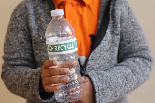 boy holding a recyclable plastic bottle