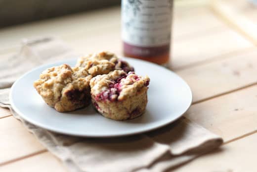 vegan-muffins-1 3 raspberry vegan muffins on a plate next to a bottle of tea