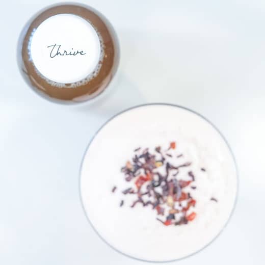 health-benefits-of-hibiscus-tea bottle of tea next to a hibiscus drink